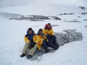 Dad and children sitting in snow 
