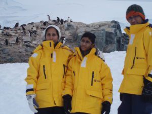 Family posing in front of penguins