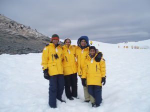 Family posing in front of penguins