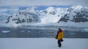 Teenager posing in front of Antarctic landscape