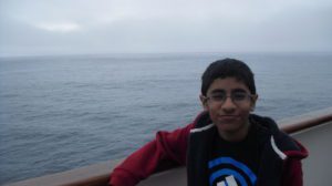 Teenager posing in front of Arctic Ocean on boat
