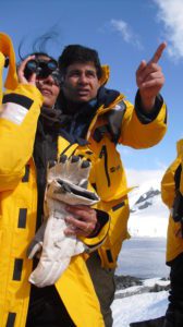 Man and woman peering in binoculars