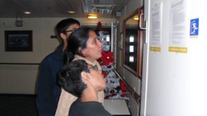 Family reading daily notices on cruise ship