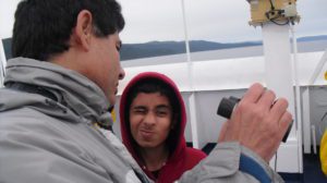 Teenager and man with binoculars