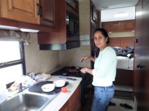 Woman cooking on caravan stovetop
