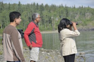 People staring across Yukon lake