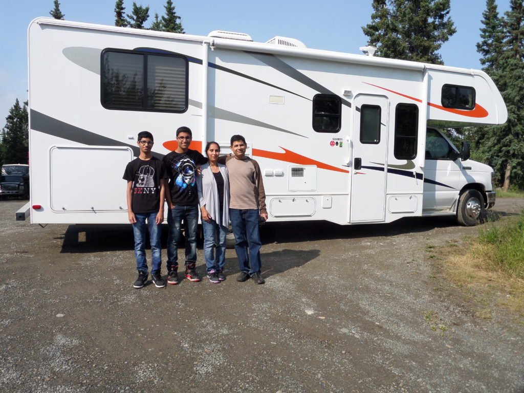 Family standing in front of caravan