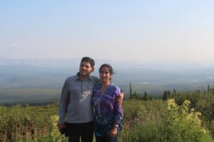 Man and woman posing in front of tundra wilderness