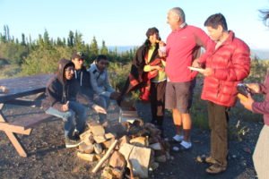 People sitting around campfire