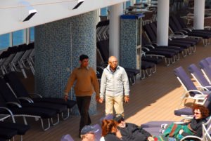 Men walking down cruise ship pool side
