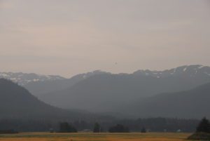 Helicopter flying above Alaskan mountain range