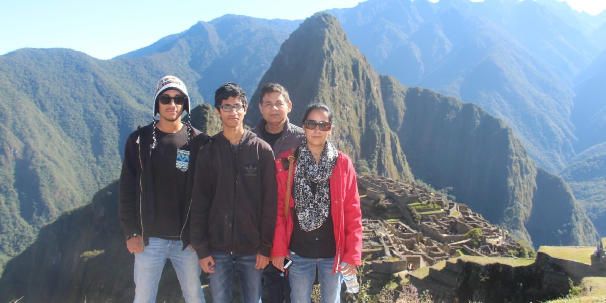 Family posing in front of Machu Pichu