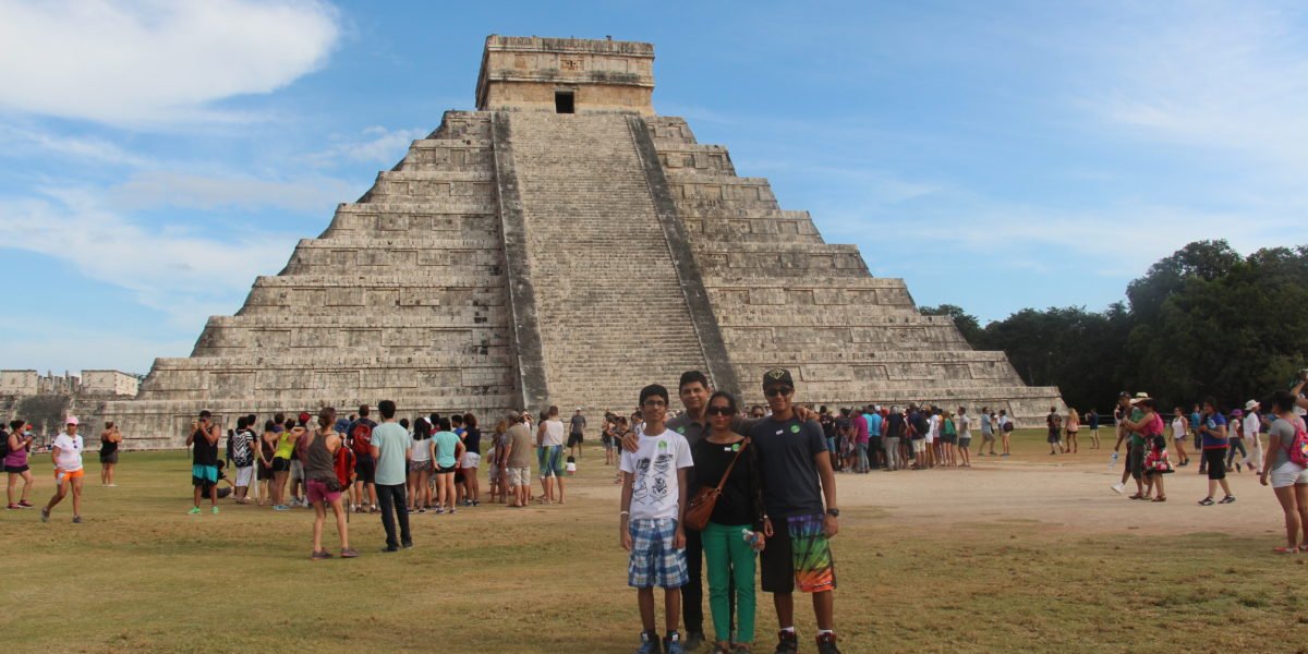 Family posing in front of Mayan ruins