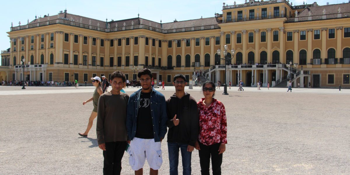 Family standing in front of European buildings